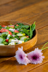 healthy green mix salad in bowl with spinach, tomato, oil and cucumber