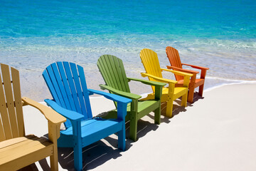 Colored beach  chairs on white sand 