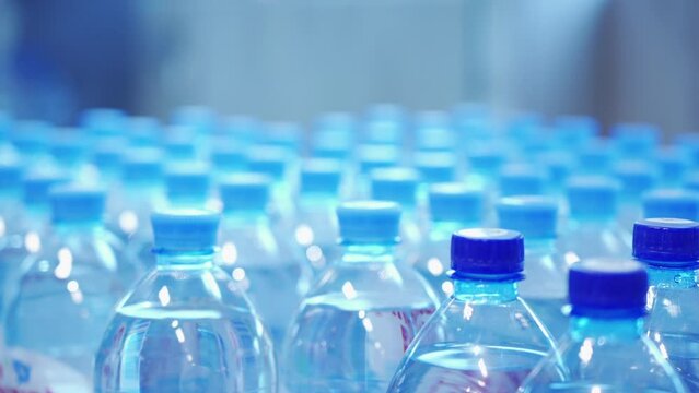 A woman chooses bottled water in a grocery store