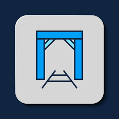 Filled outline Mine entrance icon isolated on blue background. Vector