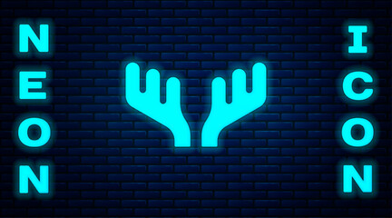 Glowing neon Deer antlers icon isolated on brick wall background. Hunting trophy on wall. Vector