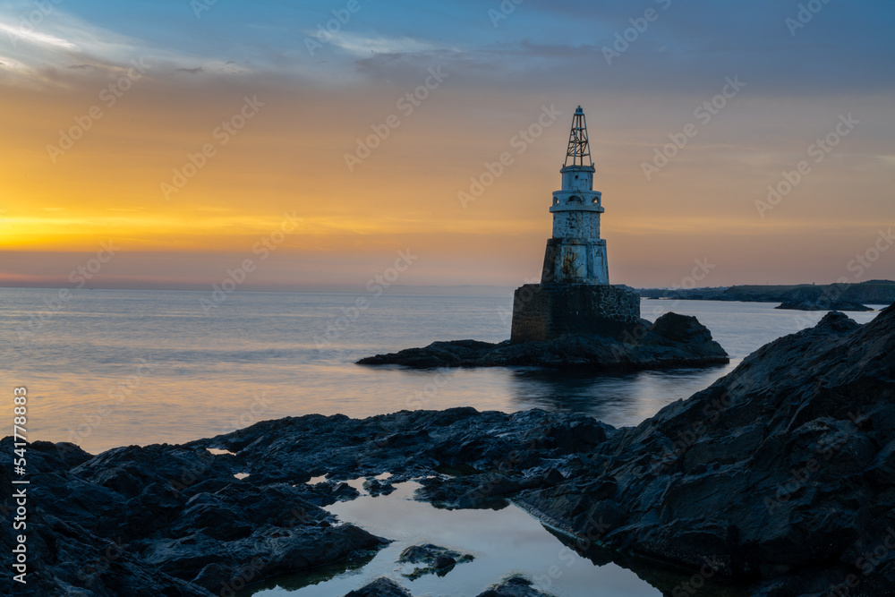 Wall mural Athopol Lighthouse on the Black Sea coast of Bulgaria with tidal pools in the foreground at sunrise