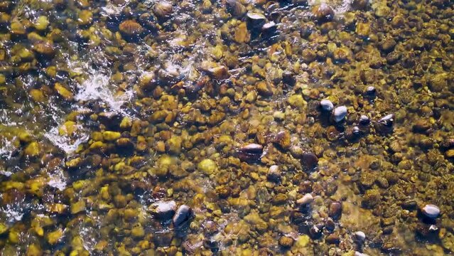 Closeup of river rocks in stream near Lake Estes in Estes Park, Colorado