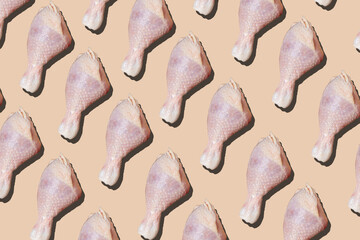 Chicken drumstick pattern on a pink background. Background of chicken pieces