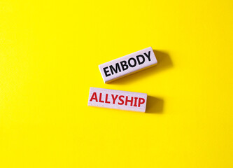 Embody Allyship symbol. Concept word Embody Allyship on wooden blocks. Beautiful yellow background. Business and Embody Allyship concept. Copy space