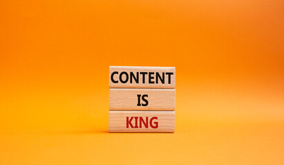 Content is king symbol. Concept words Content is king on wooden blocks. Beautiful orange background. Business and Content is king concept. Copy space.