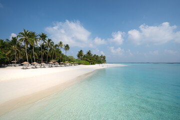 Turquoise water and sandy beach at a resort in Noonu Atoll, Maldives