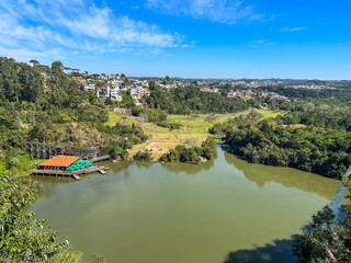 Fototapeta premium Tanguá Park Viewpoint overlooking the lake and houses, Curitiba, Parana State, Brazil. 2022-08-14