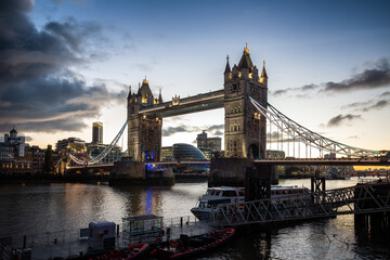 Historic Bridge over River Thames and Cityscape Skyline during dramatic sunset. Tower Bridge in City of London, United Kingdom. Travel Destination