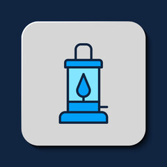 Filled outline Camping lantern icon isolated on blue background. Vector