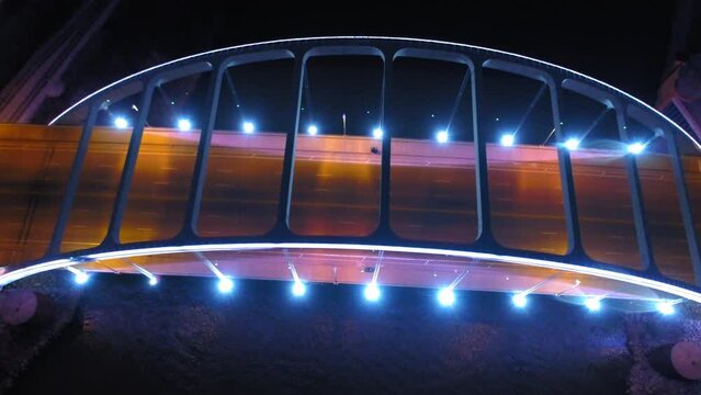 Aerial Tilt Up Shot Of Illuminated Famous Bridges In City, Drone Flying Backwards Cumberland River - Nashville, Tennessee