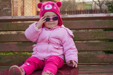 glamorous little girl in glasses,happy childhood girl in pink glasses fashionable funny and...