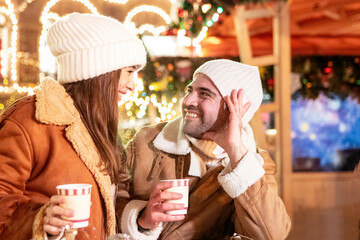 couple in love walks on the New Year's street of the evening city
