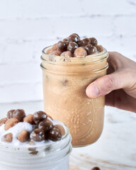 hand holding a glass of smoothie