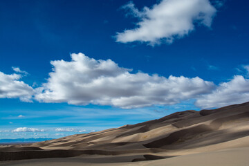 Amazing view to the Great Sand Dunes.. Dunes ant clouds in the sky. Very colorful landscape
