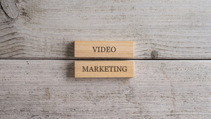 Video marketing sign written on a stack of two wooden pegs