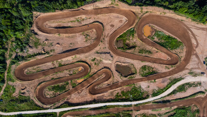 Sport. Motorsport, motocross. Dirt track for motocross, top view from a drone. Summer cloudy day. - obrazy, fototapety, plakaty