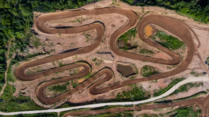 Foto op Plexiglas Sport. Motorsport, motocross. Dirt track for motocross, top view from a drone. Summer cloudy day. © Павел Шульмин