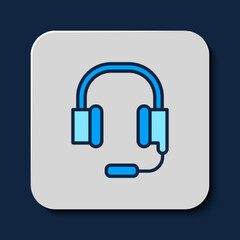 Filled outline Headphones with microphone icon isolated on blue background. Vector