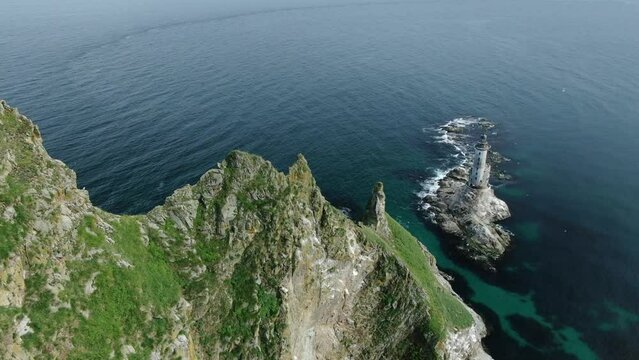Approaching from above to Aniva Lighthouse at Sakhalin Island in Japanese sea in Russia. Aerial View with copyspace