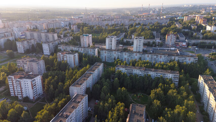Obraz premium City, locality. Construction site, residential area on a sunny summer day. Apartment buildings, high-rise buildings. The view from the drone, from above.