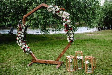  wedding arch decorated with white flowers and greenery outdoors, copy space. Wedding setting....