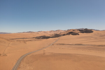 Fototapeta na wymiar Aerial view of mountains and a road in the atacama desert near the city of Copiapó, Chile