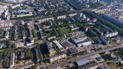 Naklejka premium City, locality. Construction site, residential area on a sunny summer day. Apartment buildings, high-rise buildings. The view from the drone, from above.