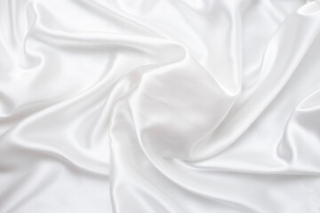 Obraz premium Elegant white silk or satin texture swirl that can be used as a mockup for products.