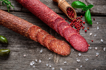 Best quality italian salami on old wooden table.