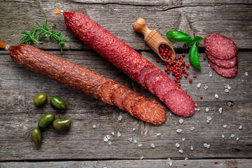 Best quality italian salami on old wooden table.