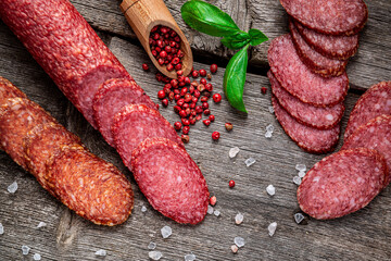 Best quality italian salami on old wooden table.