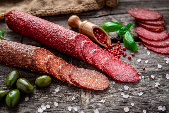 Best quality italian salami on old wooden table.