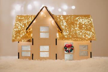 Miniature plywood dollhouse with christmas decorations and sparkling roof