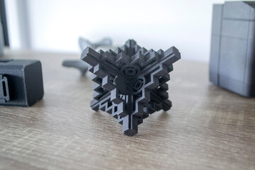 Prototype model printed with powder 3D printer close-up. Abstract black figure printed on a 3D...