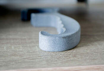 Prototype model printed with powder 3D printer close-up. Abstract black figure printed on a 3D printer from polyamide powder. Multi Jet Fusion MJF. New additive modern progressive 3D priner technology