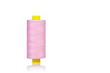 skein of thread pink colors macro on a white background