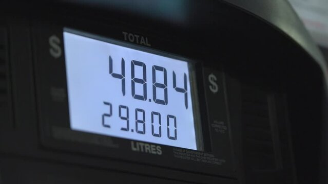 Screen in a gas pump showing rising gas prices