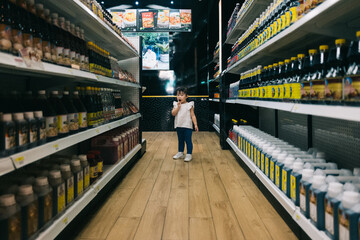 Little asian girl in supermarket