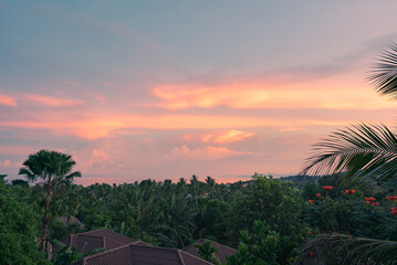 Colorful sunset sky over the sea, forest and mountain on a tropical island.View from the top.