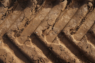 Wheel tracks on dirt soil