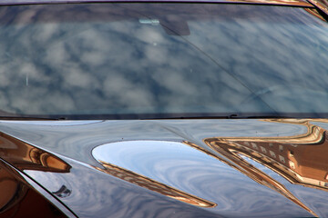 Cluds reflections on a car