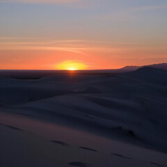 Fototapeta na wymiar Desert sand dunes at night with sunset