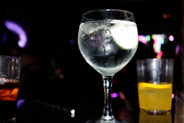 glass and glasses in discotheque on table with lights
