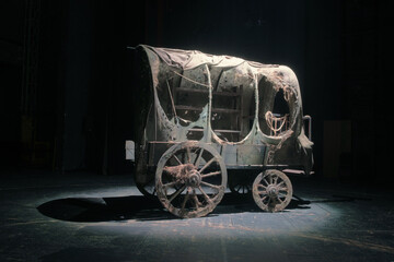 Vintage wooden wagon or carriage on the dark black background