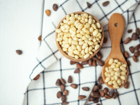 tasty and healthy pine nuts in a wooden bowl and spoon