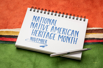 November - National Native American Heritage Month, handwriting in a sketchbook against abstract paper landscape, reminder of historical and cultural event