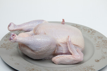 raw whole chicken on the table © Miriana