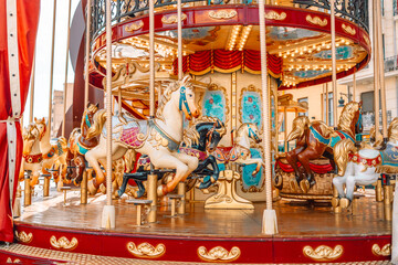 Old carousel in the park. Three horses and a plane on a traditional fair carousel. Carousel with horses in Barcelona, ​​Spain