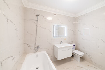 Fototapeta na wymiar bathroom interior design with light tiles and lighting
